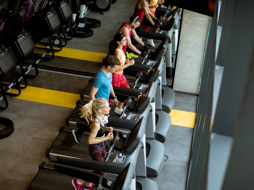 Row of runners on treadmills in a gym
