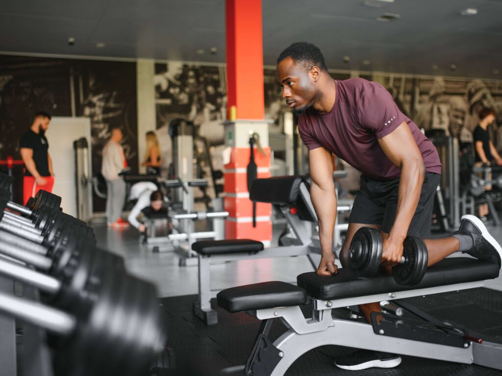 Man performing dumbbell exercises on bench