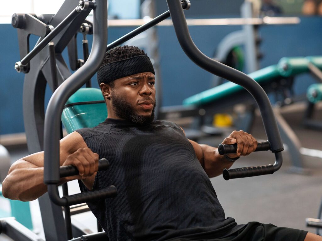 Man doing chest presses on workout machine