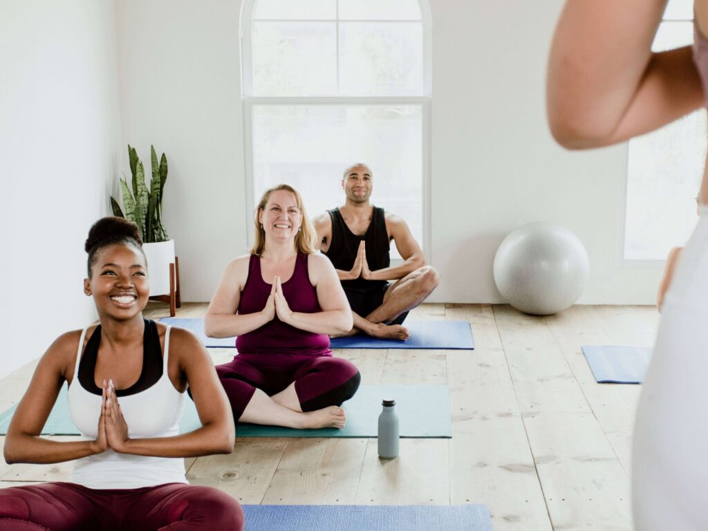 Women smiling while holding yoga pose