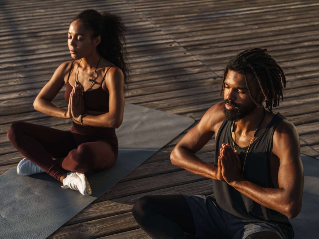 Two people holding calming yoga pose